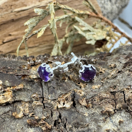 Sterling silver studs with flower bezel on rustic wood display