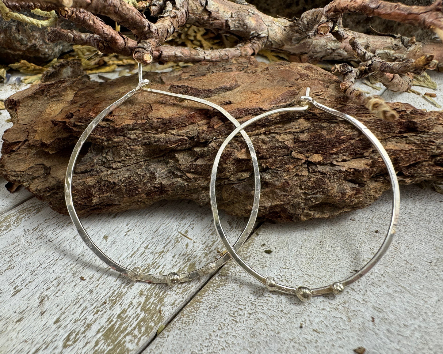 Medium Sterling Silver Hammered hoops with three silver ball accents on each by Rust and Leaf