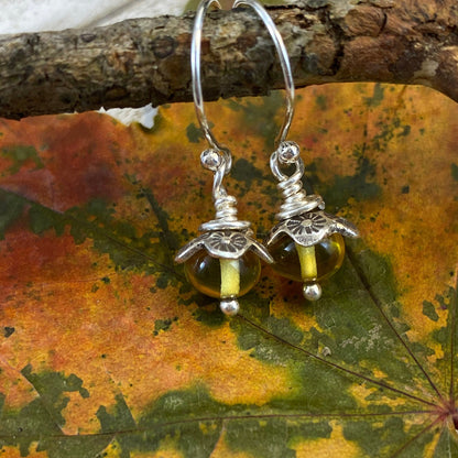 Fine Silver and Sterling Silver Baltic Amber Dangle Earrings on a colorful autumn maple leaf background