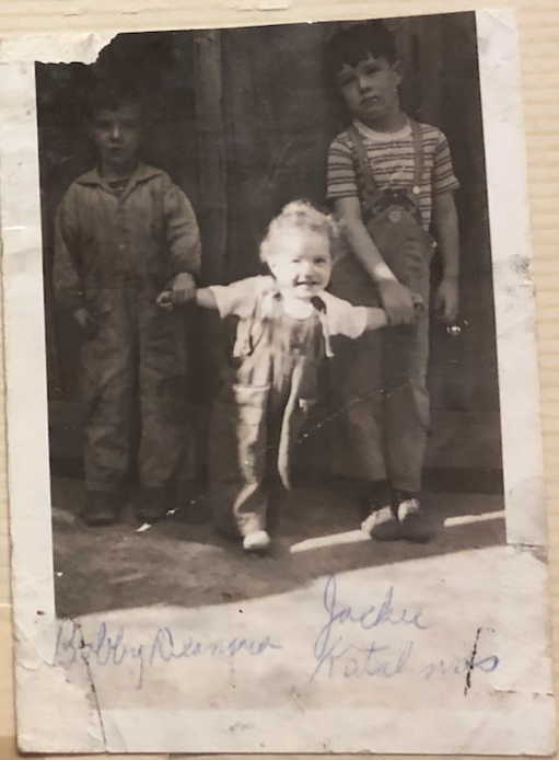 Vintage black and white photo of three children in overalls standing together in 1939 Shenandoah, PA.