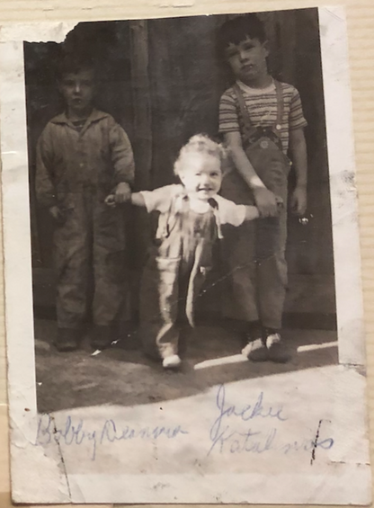 Vintage black and white photo of three children in overalls standing together in 1939 Shenandoah, PA.
