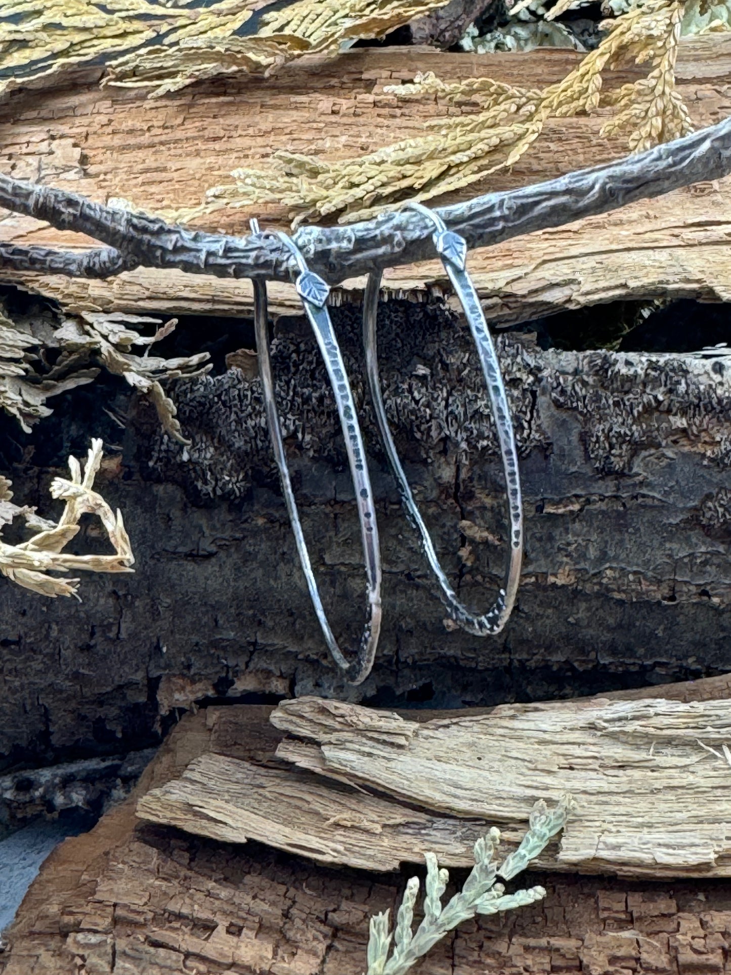 Sterling Silver Free Spirit Hoops with multi texture on tree branch showing hand forged leaf ear wire detail