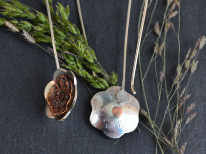 Gypsy Flower Earrings with Vintage Pansy showing a view of Rust and Leaf's maker's mark and copper rivet detail