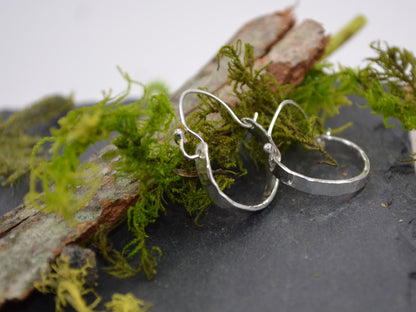 Sterling Silver Minimalist Hammered Hoops on slate with wood and moss accents