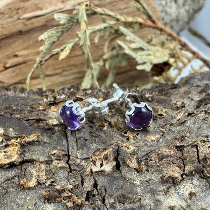 Sterling silver studs with flower bezel on rustic wood display