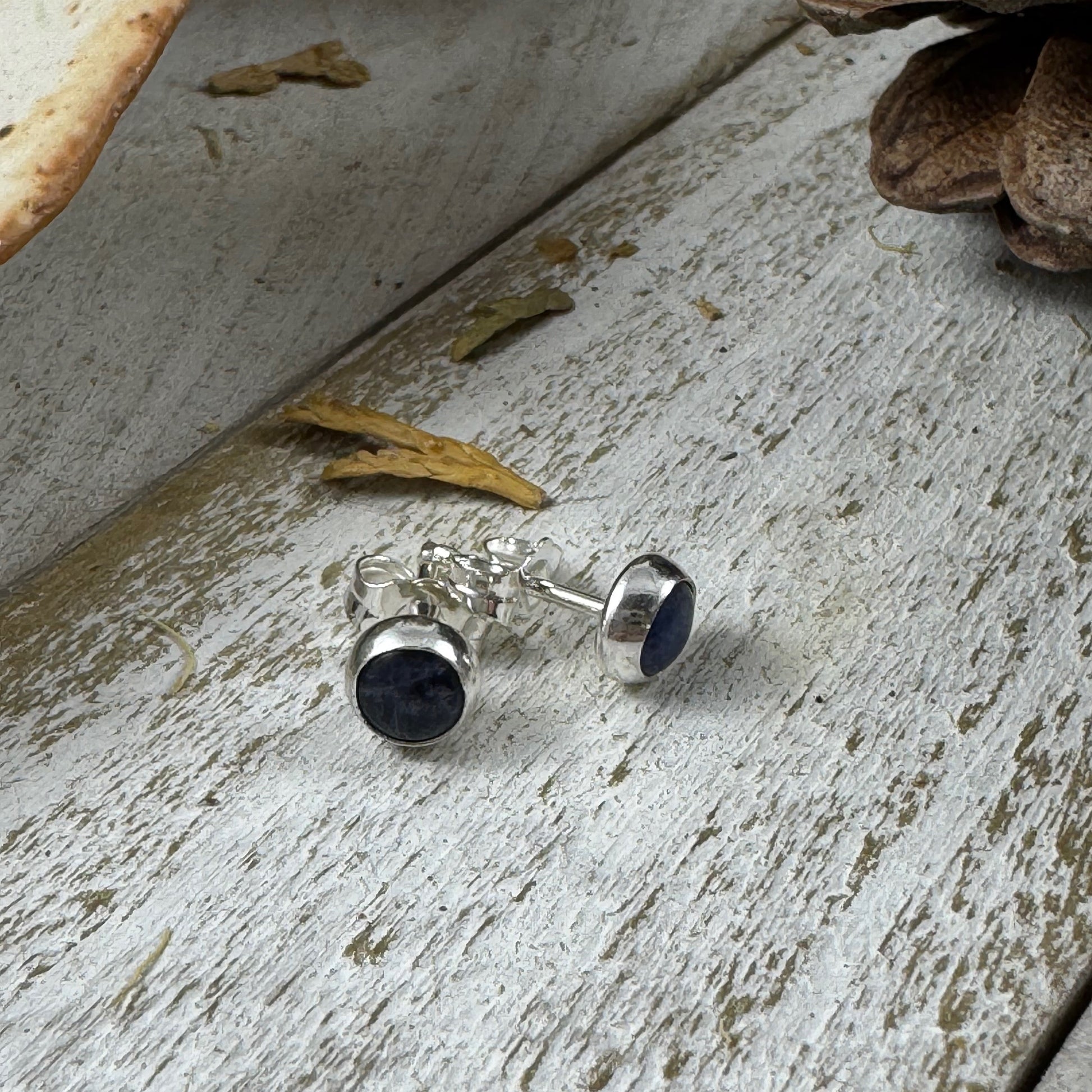 Fine Silver bezel stud earring in Sodalite on white rustic wood background