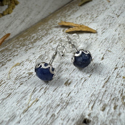 Sterling silver flower bezel stud earring in Sodalite on white rustic wood background