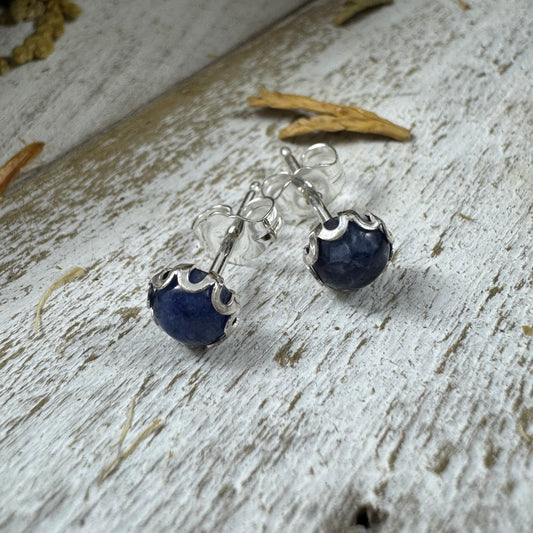 Sterling silver flower bezel stud earring in Sodalite on white rustic wood background