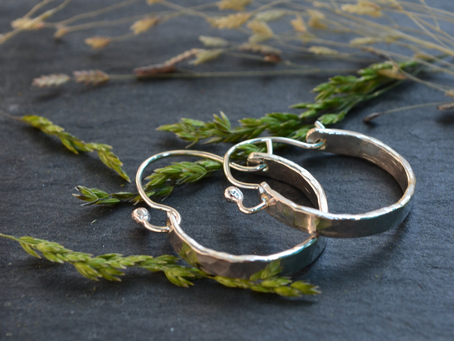 Sterling Silver Minimalist Hammered Hoops by Rust and Leaf on slate with wood and moss accents