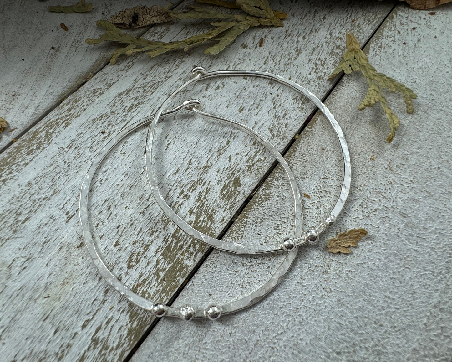 Medium Sterling Silver Hammered hoops with three silver ball accents on each by Rust and Leaf