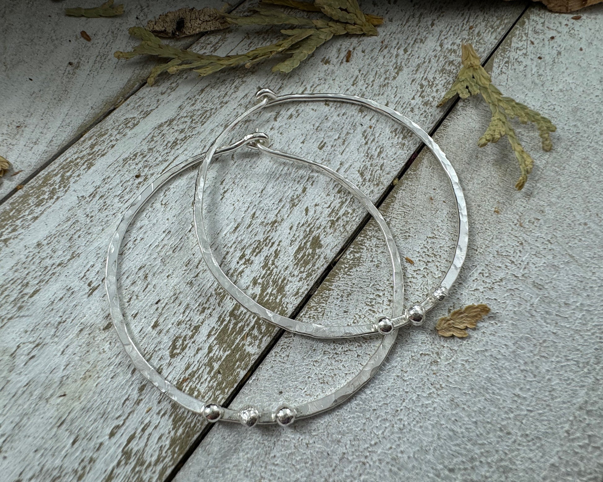Medium Sterling Silver Hammered hoops with three silver ball accents on each by Rust and Leaf