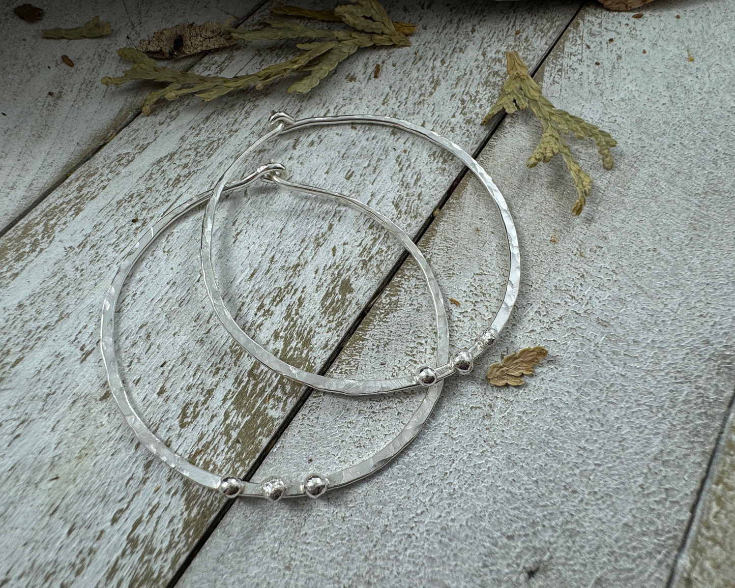 Medium Sterling Silver Hammered hoops with three silver ball accents on each by Rust and Leaf