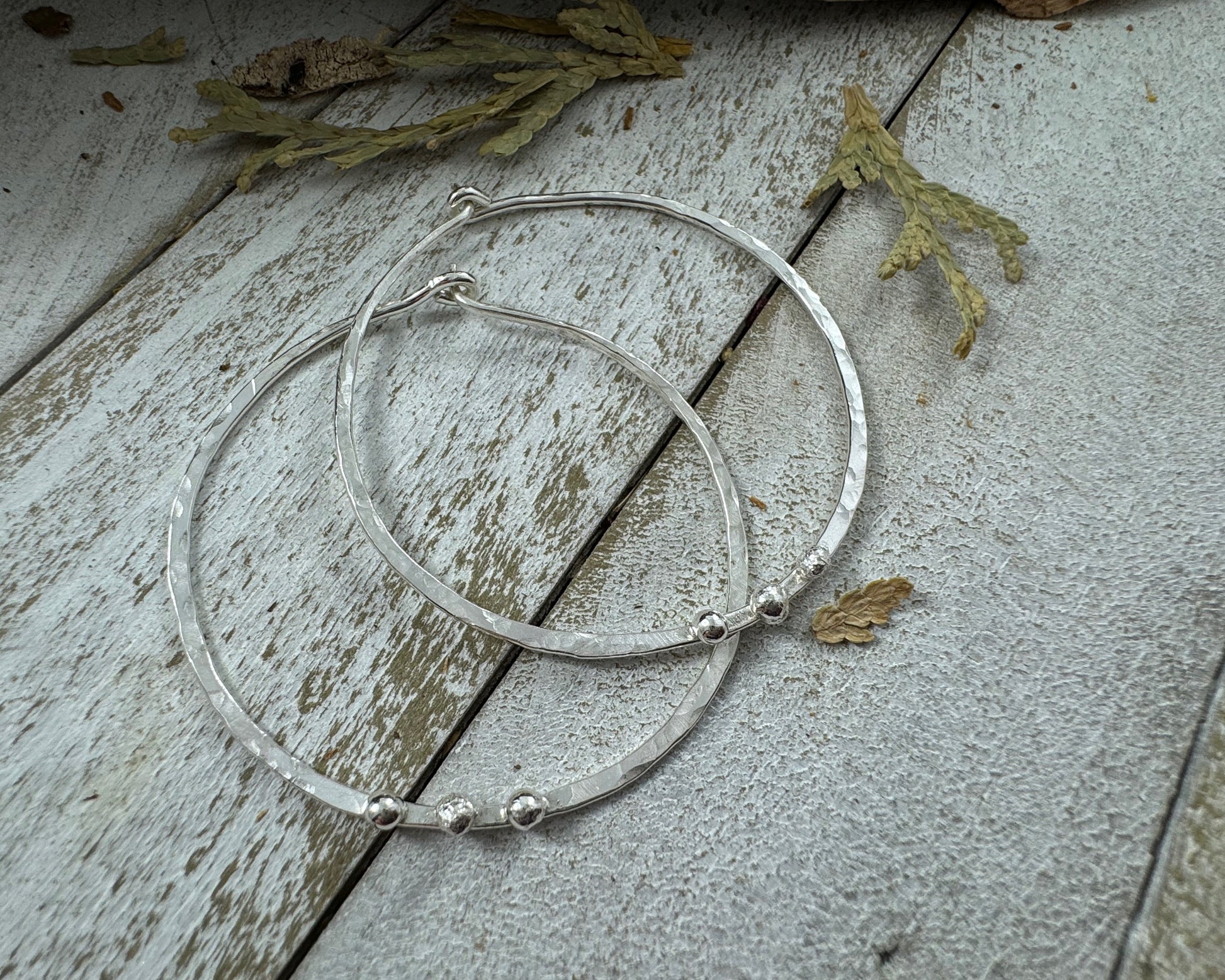 Medium Sterling Silver Hammered hoops with three silver ball accents on each by Rust and Leaf