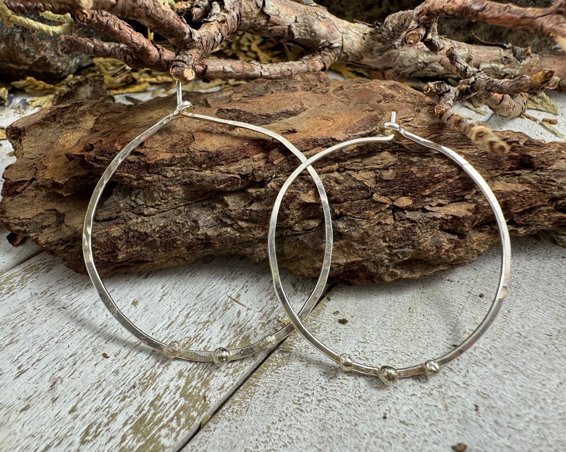 Medium Sterling Silver Hammered hoops with three silver ball accents on each by Rust and Leaf