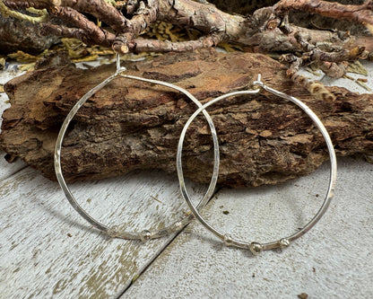 Medium Sterling Silver Hammered hoops with three silver ball accents on each by Rust and Leaf