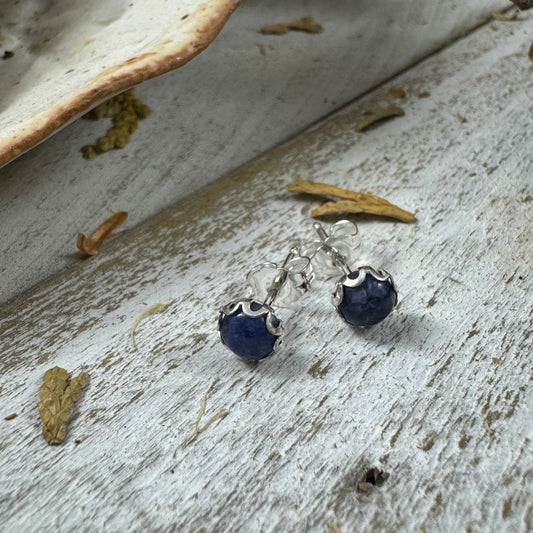 Sterling silver flower bezel stud earring in Sodalite on white rustic wood background