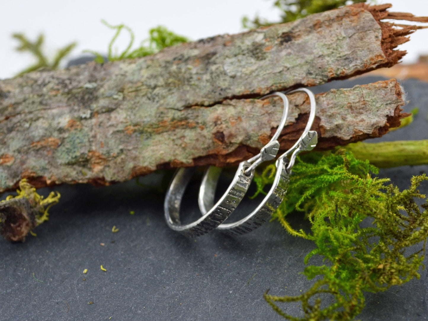 Tree Bark Hoops displayed on wood with slate underneath and moss accents